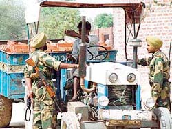 BSF personnel at a checking point near the local branch of Dera Sacha Sauda at Salabatpura