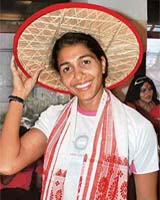 India�s ace long jumper Anju Bobby George wears a traditional Assamese japi, hat and gamocha on her arrival at Guwahati