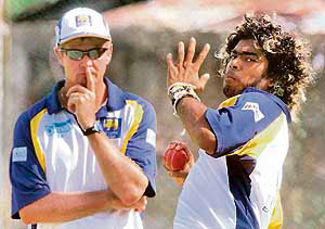 Sri Lanka�s coach Trevor Penney watches Lasith Malinga bowl during a practice session 