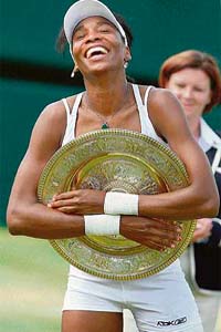 Venus Williams holds the trophy after defeating Marion Bartoli in the final at Wimbledon