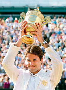 Swiss Roger Federer holds the trophy after defeating Spanish Rafael Nadal in the final at Wimbledon on Sunday. Federer won 7-6, 4-6, 7-6, 2-6, 6-2.