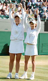 South Africa�s Liezel Huber (left) and Zimbabwe�s Cara Black hold their trophies after defeating Japan�s Ai Sugiyama and Slovenia�s Katarina Srebotnik in the women�s doubles final at Wimbledon on Sunday.