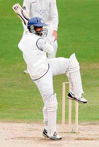 Dinesh Karthik hooks a ball from Sussex bowler Jason Lewry during their tour match in Hove