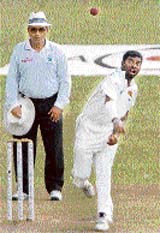 Sri Lankan cricketer Muttiah Muralitharan delivers a ball during the second day of the third and final Test against Bangladesh in Kandy on Thursday.