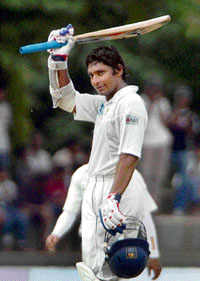 Sri Lanka�s Kumar Sangakkara raises his bat on completing his century on the third day of the third and final Test against Bangladesh at the Asgiriya Stadium in Kandy