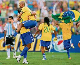 Brazilian players Julio Baptista (2L) and Gilberto(3L) celebrate at the end of the final match of the Copa America 2007 against Argentina at Pachencho Romero stadium in Maracaibo on Sunday night. Brazil won 3-0 and obtained the 42nd edition of the Copa America tournament.