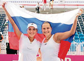 Russia�s Elena Vesnina (left) and Nadia Petrova celebrate after beating USA�s Venus Williams and Lisa Raymond 7-5, 7-6 in the Fed Cup tennis semifinal in Stowe, Vermont, on Sunday. Russia won 3-2 to advance to the final, where they will face Italy.