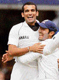 Zaheer Khan (left) celebrates with Dinesh Karthik after dismissing England�s Kevin Pietersen on the second day of the first Test at Lord�s in London on Friday.