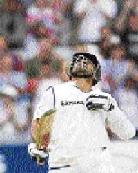 Sachin Tendulkar gestures on completing 11,000 runs on the second day of the second Test against England at Nottingham