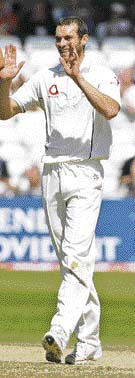 Lanky fast bowler Chris Tremlett (R) tested Indian batsmen with a fiery spell on a wearing pitch