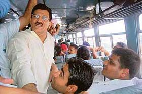 Master Mohan Lal, Punjab transport minister, interacts with passengers on a roadways bus during a journey from Chandigarh to Rajpura
