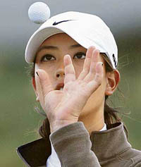 Michelle Wie from the USA catches her ball after putting at the 15th hole while taking part in the the Ricoh Women's British Open pro-am golf competition at the Old Course in St. Andrews, Scotland on Wednesday.