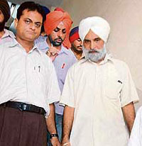 Registrar of Punjabi University Baldev Singh Sandhu comes out after being produced in a court in Patiala