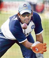 Mahendra Dhoni takes part in a practice session at the Oval cricket ground in London on Tuesday, two days before the third and final cricket Test between England and India. 
