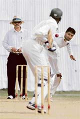 India A's Pankaj Singh (R) bowls to Kenya's Collins Obuya (C) during the three-day match in Kenya's coastal town of Mombasa, 500 km from Nairobi.