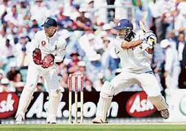 Mahendra Singh Dhoni plays a shot off the bowling of England�s Monty Panesar as wicketkeeper Matt Prior looks on during the second day of the third Test at the Oval on Friday.