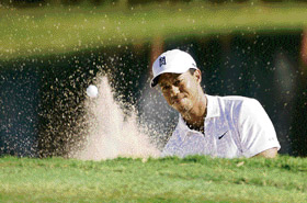 Tiger Woods plays a bunker shot on the 13th hole during the second round of the 89th PGA Golf Championship at the Southern Hills Country Club in Tulsa, Oklahoma