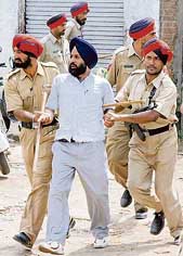 An Akali worker rounded up by the police for violence during re-polling for the MC election at ward No. 29 in Amritsar on Sunday.