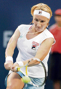Russia's Svetlana Kuznetsova returns a shot to Italy's Roberta Vinci during their match at the Rogers Cup tennis tournament in Toronto.