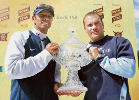 Indian captain Rahul Dravid and Scotland's captain Rayn Watson pose with the Royal Stag trophy at Glasgow on Wednesday