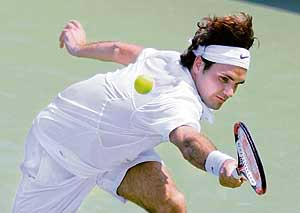 Roger Federer of Switzerland returns a shot from Nicolas Almagro of Spain during their quarter-final match. 