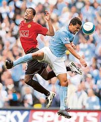 Manchester City�s Geovanni (right) fights for the ball with Manchester United�s Patrice Evra during the English Premier League football match