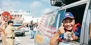 A car rally marking the golden jubilee celebrations of Malaysia crosses over to India through the Wagah checkpost, near Amritsar, on Monday.