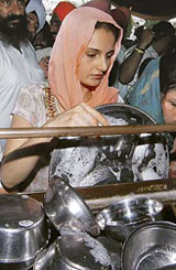 Bollywood actress Monica Bedi washes dishes at the Golden Temple in Amritsar on Monday.
