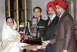 Dr Jai Rup Singh, Vice-Chancellor, and Dr. Kanwaljit Singh, director, sports, of Guru Nanak Dev University, Amritsar, receiving Maulana Abdul Kalam Azad (MAKA) Trophy 2005-06 for the best all round performance in sports from President Pribha Patil at a function in New Delhi on Wednesday. 