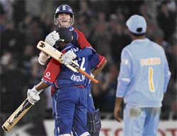 Stuart Broad (facing camera) and Ravi Bopara celebrate as Dinesh Karthik looks on after England won the fourth one-dayer at Old Trafford in Manchester on Thursday. 