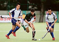 Pakistan�s Rehan Butt (centre) fights for the ball with a Japanese defender during their Asia Cup match in Chennai on Saturday.