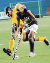 Prabhjot Singh (right) vies for the ball with a Sri Lankan player during a pool match of the Asia Cup hockey tournament in Chennai on Saturday.