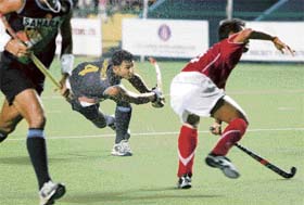 Raghunath (C) is watched by a teammate (L) and a Thai player (R) after he played a shot to score a goal during a first round match for the seventh Asia Cup hockey tournament in Chennai