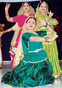 Girls perform a classical dance during a cultural programme on the college campus.