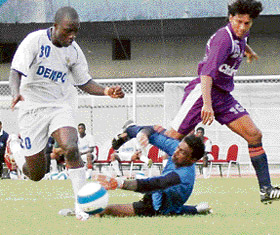 Dempo Sports Club�s Chidi Edeh (left) beats Chirag United goalkeeper Arindam Ghosh during a pre-quarterfinal of the 29th Hero Federation Cup at Guru Nanak Stadium, Ludhiana