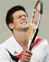 Novak Djokovic of Serbia grimaces after losing a point in the second set against Roger Federer of Switzerland during the men's final of the U.S. Open tennis tournament in Flushing Meadows, New York, on Sunday.