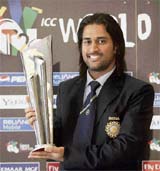Indian captain Mahendra Singh Dhoni poses with a Twenty20 World Championship cricket trophy, following a media briefing in Johannesburg, South Africa, Monday