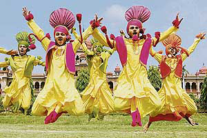 Youths jump to the beat of the dhol at the opening ceremony of the 13th Punjab Police Border Range Sports and Athletics Meet at Khalsa College in Amritsar on Thursday. � AFP