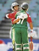 Bangladesh�s Aftab Ahmed (back towards camera) celebrates with Mohammad Ashraful after completing his fifty during their Twenty20 World Cup match against the West Indies in Johannesburg
