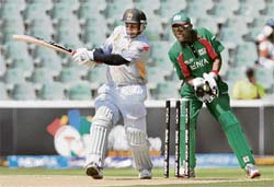 Sanath Jayasuriya plays a shot as Maurice Ouma looks on during the Twenty20 World Cup match in Johannesburg