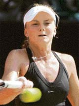 Slovakia�s Daniela Hantuchova hits a return to Japan�s Ayumi Morita during the quarterfinal of the Bali International tennis tournament in Nusa Dua