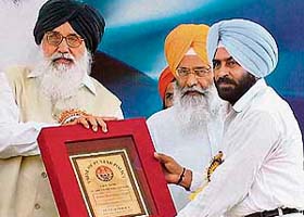 Pargat Singh (right) receives the lifetime achievement Police Sports Award from Punjab Chief Minister Parkash Singh Badal at a function at Jalandhar