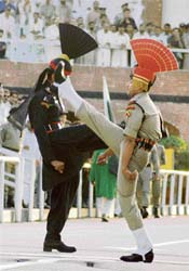 A BSF jawan and a Pakistani Ranger march in perfect drill during the Beating the Retreat ceremony at the Attari checkpost. The timing of the ceremony has been changed in view of the shortening of days