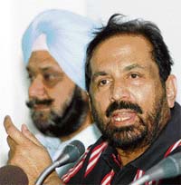 Indian Olympic Association president Suresh Kalmadi (right) addresses a press conference as secretary-general Randhir Singh looks on in New Delhi on Monday.