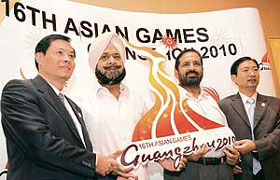 IOA president Suresh Kalmadi (second from right), secretary general of IOA Randhir Singh(second from left) and director marketing, GAGOC, Fang Daer (left) hold the Guangzhou 2010 Asian Games logo in New Delhi on Tuesday.
