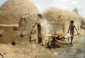 A hard day: Twelve-year-old Arif works at a kiln in Balina village on the Hisar road near Pehowa.
