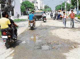 A view of potholed roads in the Urban Estate area in Panipat. Tribune photo: Ravi Kumar