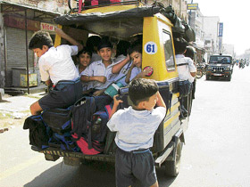 An autorickshaw overloaded with schoolchildren in Ambala.