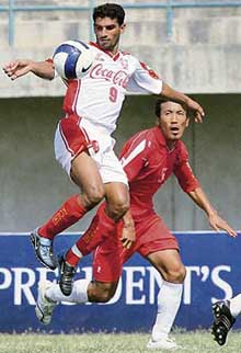 Pakistan's army football player Faheem Riaz (L) vies with Passang Tshering of Bhutan during their Asian Football Confederation (AFC) President Cup Football Tournament match in Lahore on Tuesday. Bhutan won the match 3-2.