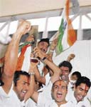 ictorious Indian team members raise the ICC Inaugural Twenty20 World Cup at a celebratory rally from Mumbai's international airport to the Wankhede stadium